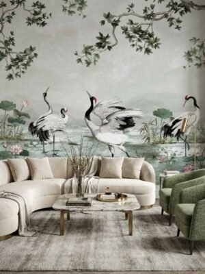Luxury neutral grey mural wallpaper featuring elegant cranes, lotus flowers, and botanical branches in a serene landscape design, styled in a modern living room with beige sofa and green armchairs by RUBY Furnishing Studio Ghatkopar East Mumbai.