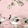 Elegant pink mural wallpaper featuring artistic cranes, lotus elements, and delicate tree branches with green leaves, styled with modern blue lounge chairs in a luxury interior by RUBY Furnishing Studio Ghatkopar East Mumbai.