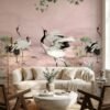 Elegant pink mural wallpaper featuring artistic cranes, lotus elements, and delicate tree branches with green leaves, styled with modern blue lounge chairs in a luxury interior by RUBY Furnishing Studio Ghatkopar East Mumbai.