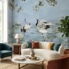 Luxury blue mural wallpaper featuring elegant cranes, lotus elements, and flowing botanical branches on a soft sky-blue background, styled with modern blue armchairs in a premium living room by RUBY Furnishing Studio Ghatkopar East Mumbai.