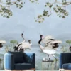 Luxury blue mural wallpaper featuring elegant cranes, lotus elements, and flowing botanical branches on a soft sky-blue background, styled with modern blue armchairs in a premium living room by RUBY Furnishing Studio Ghatkopar East Mumbai.