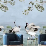 Luxury blue mural wallpaper featuring elegant cranes, lotus elements, and flowing botanical branches on a soft sky-blue background, styled with modern blue armchairs in a premium living room by RUBY Furnishing Studio Ghatkopar East Mumbai.