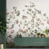 Elegant floral mural wallpaper featuring delicate botanical branches, blooming flowers, birds, and butterflies on a soft neutral background, styled with a modern green console cabinet in a luxury living room by RUBY Furnishing Studio Ghatkopar East Mumbai.
