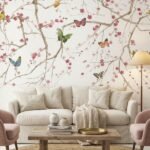 Elegant blue floral mural wallpaper with cherry blossom branches and colorful butterflies, Daisy Bennett mural collection by Ruby The Furnishing Studio, ideal for modern living room décor.