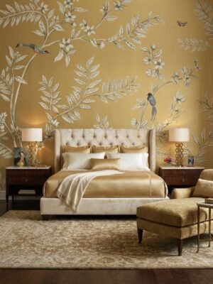 Elegant golden yellow floral mural wallpaper with delicate tree branches, blooming flowers, and birds in a luxury living room with blush seating and ornate mirror