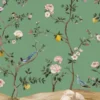 Green floral bird mural wallpaper with delicate white blossoms and perched birds, luxury botanical wall design in an elegant modern classic living room with teal sofa.