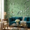 Green floral bird mural wallpaper with delicate white blossoms and perched birds, luxury botanical wall design in an elegant modern classic living room with teal sofa.