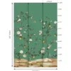 Green floral bird mural wallpaper with delicate white blossoms and perched birds, luxury botanical wall design in an elegant modern classic living room with teal sofa.