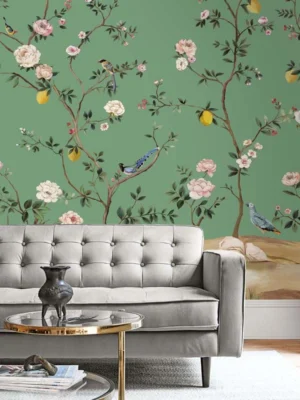 Green floral bird mural wallpaper with delicate white blossoms and perched birds, luxury botanical wall design in an elegant modern classic living room with teal sofa.
