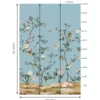 Elegant floral bird mural wallpaper with pastel blue background, featuring blooming branches, lemons, and colorful birds in a classic vintage style living room setting.