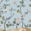Elegant floral bird mural wallpaper with pastel blue background, featuring blooming branches, lemons, and colorful birds in a classic vintage style living room setting.