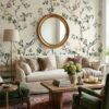 Elegant cream floral bird mural wallpaper with blooming branches and perched birds, luxury botanical wall design in a classic living room with neutral sofa and vintage decor.