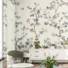 Elegant cream floral bird mural wallpaper with blooming branches and perched birds, luxury botanical wall design in a classic living room with neutral sofa and vintage decor.