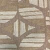Casamance FILANDRA 7698 25 48 geometric textured wallpaper in warm beige and brown tones installed on a modern living room feature wall with premium designer interior décor.