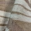 Casamance FILANDRA 7698 25 48 geometric textured wallpaper in warm beige and brown tones installed on a modern living room feature wall with premium designer interior décor.